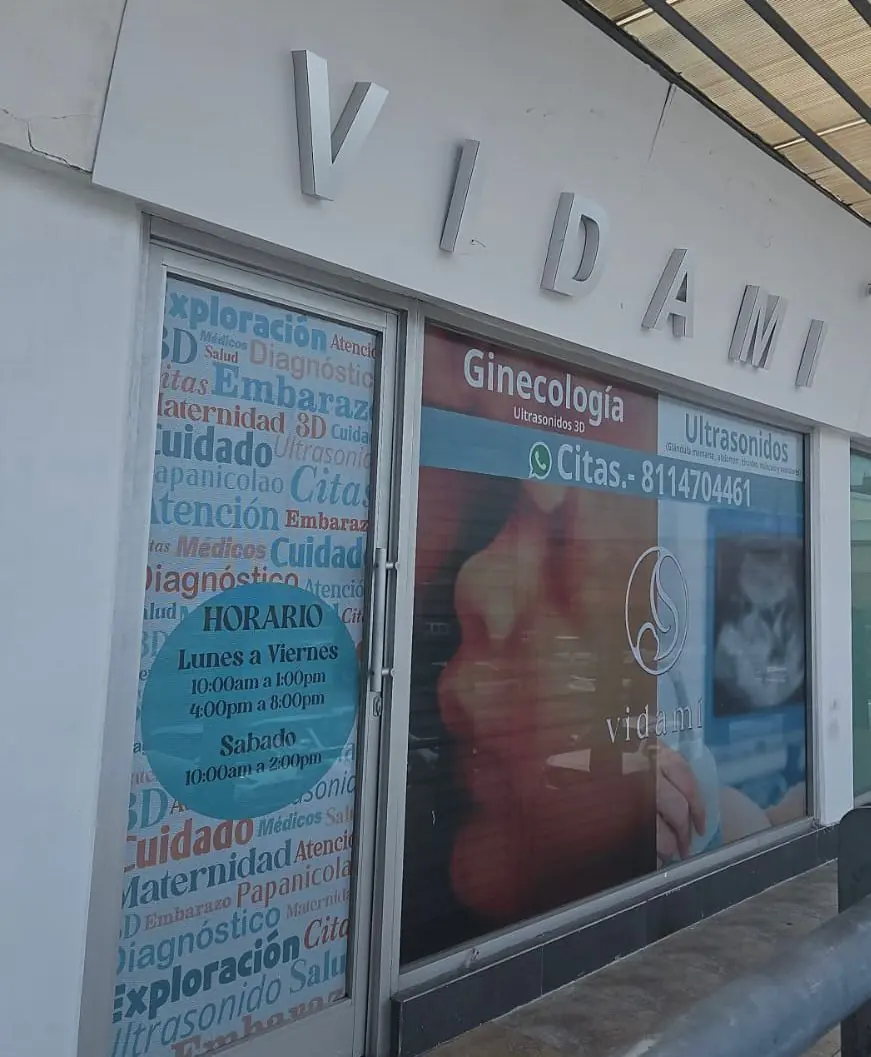 Entrada del consultorio con el letrero VIDAMI y el horario de atención en la puerta